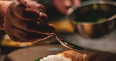 man decorating food