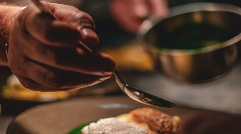 man decorating food