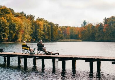 two men fishing on lake