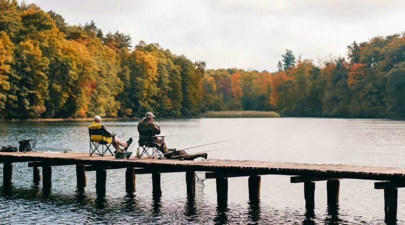 two men fishing on lake